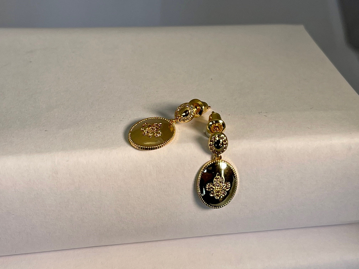 GLORIOUS GLOW  - 18ct real gold plated oval shaped earrings with a zircon fleur- de lis