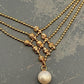 ROMANTIC INTERCHANGE-Cross over gold necklace with a fresh water pearl at the end