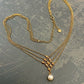 ROMANTIC INTERCHANGE-Cross over gold necklace with a fresh water pearl at the end