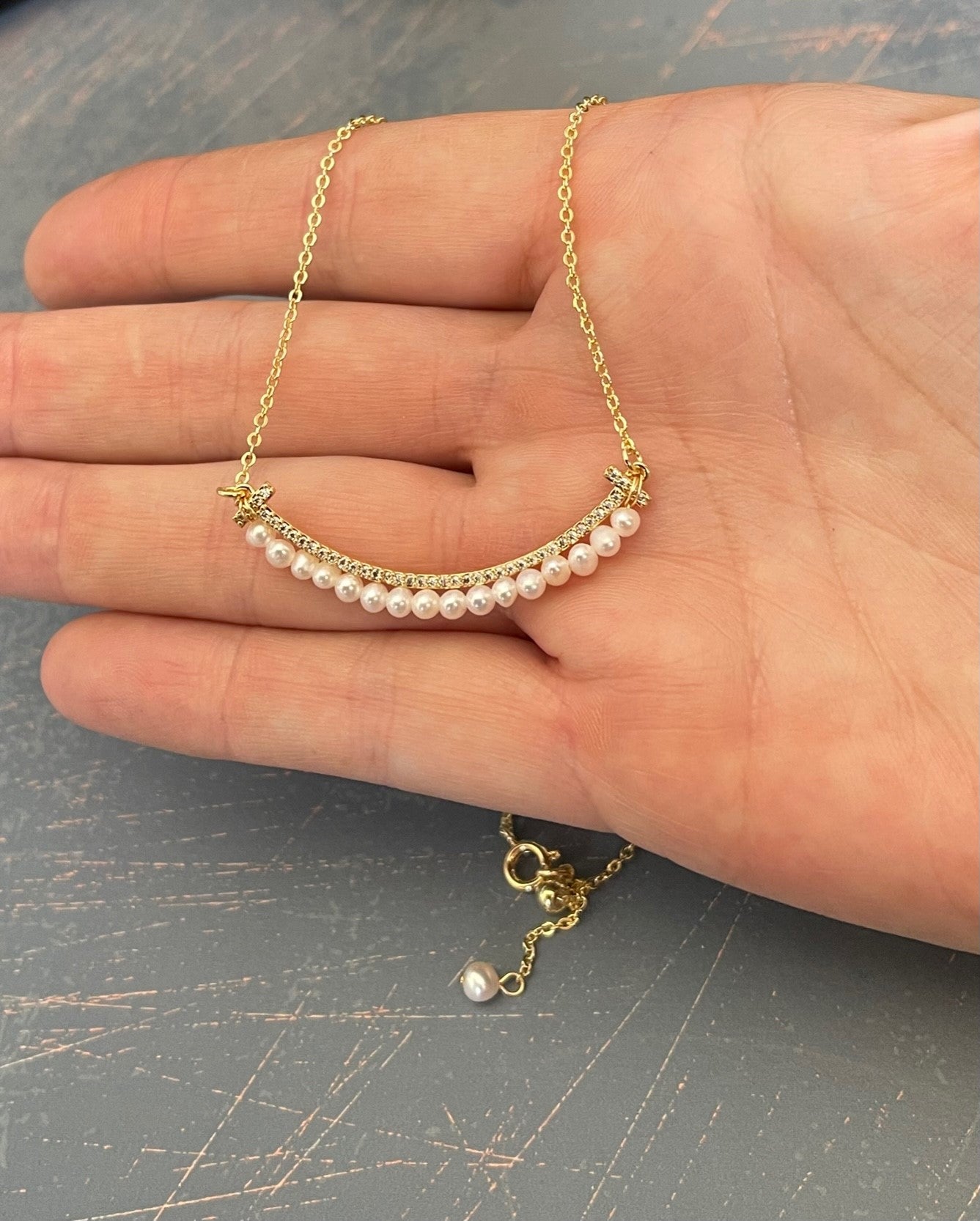 SMILEY FACE Pearl necklace with a tiny row of cubics which is 14 k gold plated